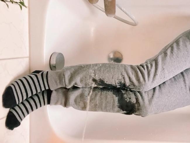 Thumbnail of Peed all over in gray sweatpants and gray striped socks (no sound)